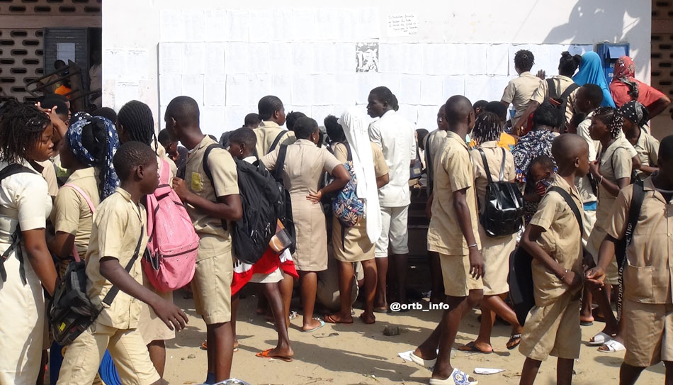 Des élèves consultent le tableau d'affichage au CEG Gbégamey de Cotonou