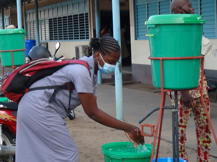 Une élève se lave les mains au Cours Secondaire Notre Dame de Cotonou